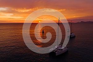Aerial view from drone on boats shipping in sea, sunset
