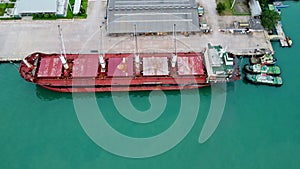 Aerial view from drone of commercial ship and cruise ship parked in the marina. Transportation and travel background, beautiful se