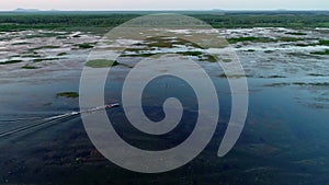 Aerial view drone flies after the Longtail boat or Tourist boat in the beautiful lake