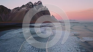 Aerial view drone flight forward and tilt,Vestrahorn mountain at sunset, Stokksnes, Iceland