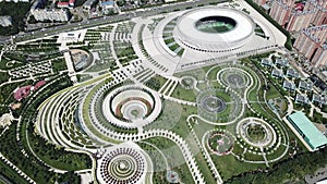 Aerial view: drone fly from modern futuristic leisure Park. Aerial footage cityscape Kuban summer, football stadium