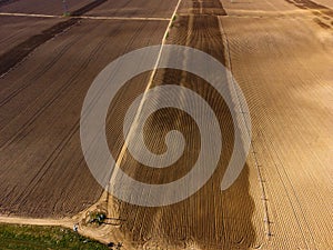 Aerial View from a Drone Flying above Green Farm Field Furrowed Sprinklers Wheel Lines Irrigation