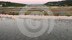 Aerial view of drone flying low with nice sunset reflection