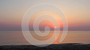 Aerial view with drone flying low over the beach with a colorful morning sunrise