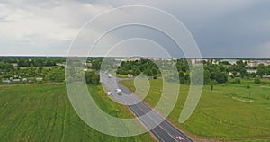 Aerial view of drone follow cars and trucks on wet road after rain is gone.