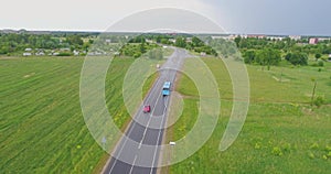 Aerial view of drone follow cars and trucks on wet road after rain is gone.