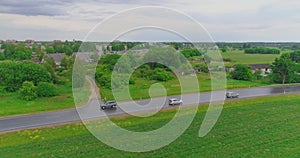 Aerial view of drone follow cars and trucks on wet road after rain is gone.