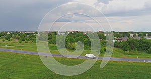 Aerial view of drone follow cars and trucks on wet road after rain is gone.