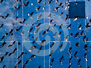 Aerial view from a drone of a group of people doing physical exercise on a jogging track