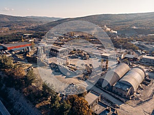 Aerial view from drone of industrial area with warehouses, buildings, trucks, industry equipment, heavy transport