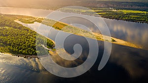 Aerial view from the drone of landscape Volga river flows among the hills and fields. The middle band of Russia