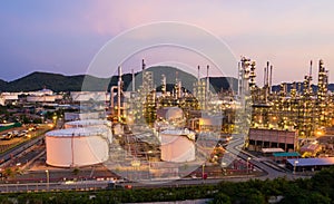 Aerial view drone of oil storage tank with oil refinery factory industrial. Oil refinery plant at beautiful sky sunset and