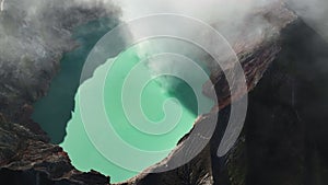 Aerial view drone orbit around to reveal Kawah Ijen volcano crater, Indonesia