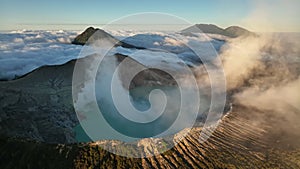 Aerial view drone orbit around to reveal Kawah Ijen volcano crater, Indonesia