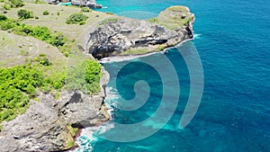 Aerial view by drone overlooking the sea. Rocky coast with high cliffs, Beach with hole on the cliff in Nusa Penida island, Bal P