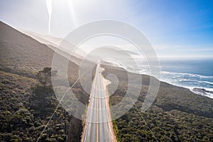 Aerial View Drone Shot of Highway Pacific Coast Highway California USA Big Sur Mountains Ocean Fog Sun