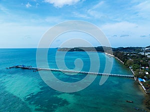 Aerial view drone shot of tropical sea at rawai beach Phuket Thailand, Beautiful scenery andaman sea and long bridge in to the sea
