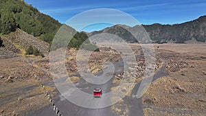 Aerial view drone tracking a car to go to Bromo volcano, Indonesia