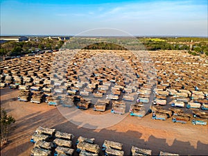 Aerial view from drone trucks loaded with sugar cane in a truck parking outside sugar cane factory