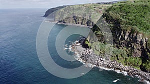 Aerial view with drone of the turquoise water of the Atlantic ocean and Acores island, Giant rocks and green forest