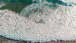 Aerial view from drone viewpoint of waves along the shoreline