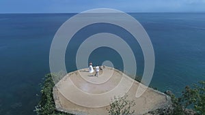 Aerial view from drone of wedding couple at the cliff