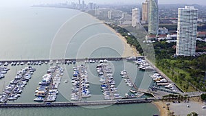 Aerial View by Drone of Yacht Club and Marina. Top view of yacht club. White boats in sea water. Marina dock yachts and