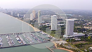 Aerial View by Drone of Yacht Club and Marina. Top view of yacht club. White boats in sea water. Marina dock yachts and