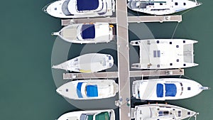 Aerial View by Drone of Yacht Club and Marina. Top view of yacht club. White boats in sea water. Marina dock yachts and