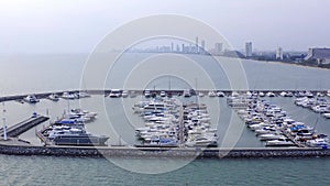 Aerial View by Drone of Yacht Club and Marina. Top view of yacht club. White boats in sea water. Marina dock yachts and