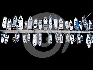 Aerial View by Drone of Yacht Club and Marina. Top view of yacht club. White boats in sea water. Marina dock yachts and small moto