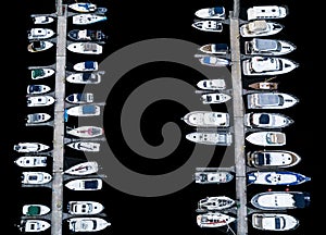 Aerial View by Drone of Yacht Club and Marina. Top view of yacht club. White boats in sea water. Marina dock yachts and small moto