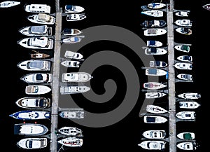 Aerial View by Drone of Yacht Club and Marina. Top view of yacht club. White boats in sea water. Marina dock yachts and small moto