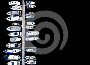 Aerial View by Drone of Yacht Club and Marina. Top view of yacht club. White boats in sea water. Marina dock yachts and small moto