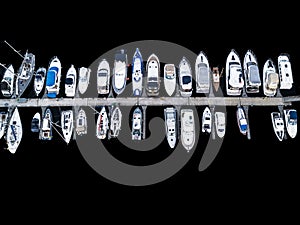 Aerial View by Drone of Yacht Club and Marina. Top view of yacht club. White boats in sea water. Marina dock yachts and small moto