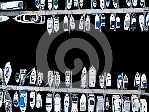 Aerial View by Drone of Yacht Club and Marina. Top view of yacht club. White boats in sea water. Marina dock yachts and small moto