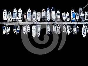 Aerial View by Drone of Yacht Club and Marina. Top view of yacht club. White boats in sea water. Marina dock yachts and small moto