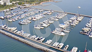 Aerial View by Drone of Yacht Club and Marina. Top view of yacht club. White boats in sea water. Marina dock yachts and
