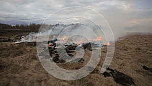 Aerial view of dry grass burning on the farmland