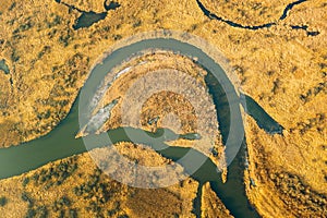 Aerial View Of Dry Grass And Partly Frozen River Landscape In Late Autumn Day. High Attitude View. Marsh Bog. Drone View