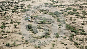 Aerial view of the dry sahel with desert livestock herders in Ethiopia near Somalia