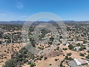 Aerial view of dry valley with houses and barn in Escondido, California photo