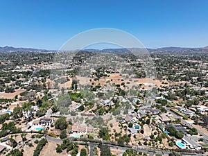 Aerial view of dry valley with houses and barn in Escondido, California photo