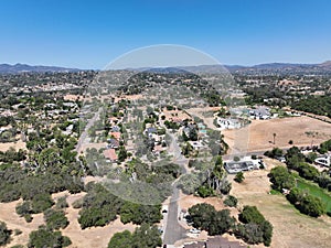 Aerial view of dry valley with houses and barn in Escondido, California photo