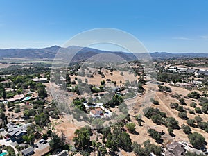 Aerial view of dry valley with houses and barn in Escondido, California photo