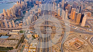 Aerial view of Dubai Downtown skyline, highway roads or street in United Arab Emirates or UAE. Financial district and business