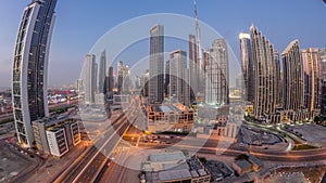 Aerial view of Dubai Downtown skyline with many towers day to night timelapse.