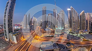 Aerial view of Dubai Downtown skyline with many towers day to night timelapse.