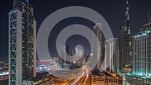 Aerial view of Dubai Downtown skyline with many towers night timelapse.