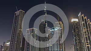 Aerial view of Dubai Downtown skyline with many towers night timelapse.